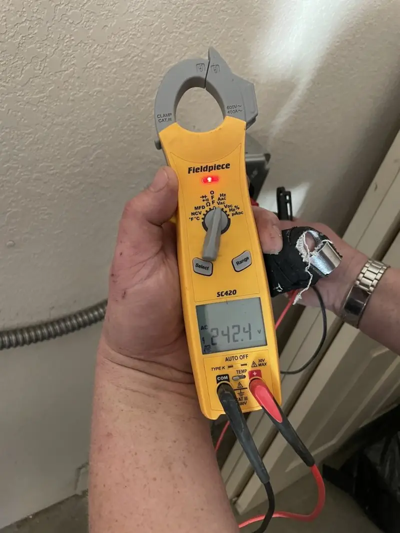 Voltage testing with clamp meter during Recessed Lighting Installation in North Codorus